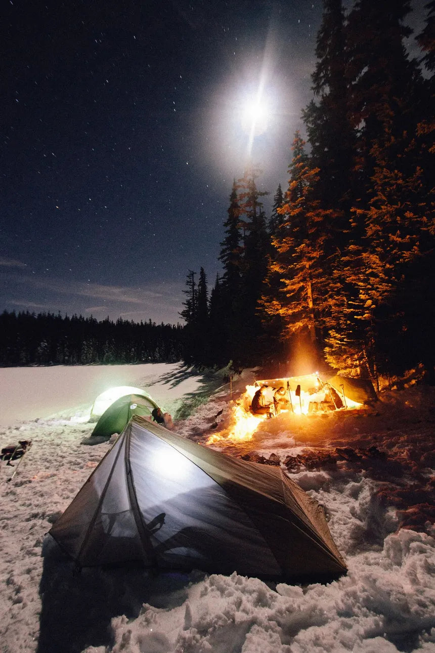Winter camping in tents surrounded by snow—illustrating the power of sleeping in a cold room to boost recovery, enhance sleep quality, and promote overall health.