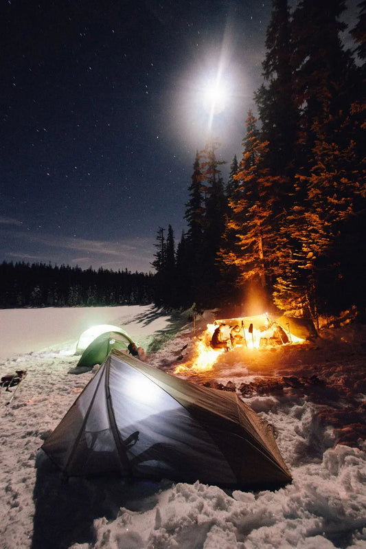 Winter camping in tents surrounded by snow—illustrating the power of sleeping in a cold room to boost recovery, enhance sleep quality, and promote overall health.