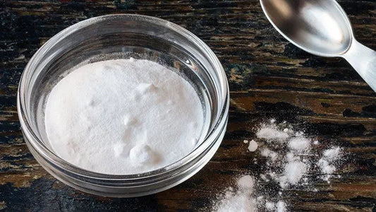 A bowl of baking soda, a versatile natural remedy, often used for digestion, hydration, and muscle recovery.