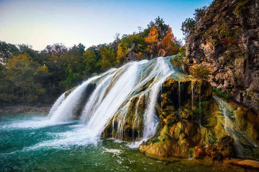 Pristine mountain waterfall cascading over rocks, symbolizing pure, natural, and mineral-rich water—essential for vitality and optimal health.