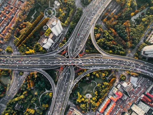 A busy highway cloverleaf in the urban jungle—symbolizing the need for aromatase inhibitors to navigate hormonal balance amidst modern environmental stress.